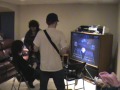 2 kids playing guitar hero 3 on the hardest settings