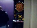 in the closing round of an intense dart game of 