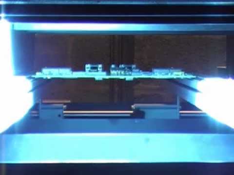 UV conformal coating - Conformal Coating on Printed Circuit Board (PCB) being cured in an inline UV Cure SMEMA pin edge conveyor.