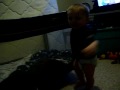 Kristopher trying to climb into his playpen