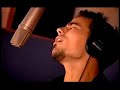 merci, from damien sargue. he is singing at a studio.