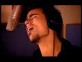 merci, from damien sargue. he is singing at a studio.
