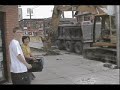 tearing up the sidewalk with a loader and putting in dumptruck.