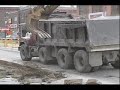 tearing up the sidewalk with a loader and putting in dumptruck.