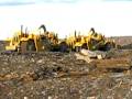 657 Cat scrapers backfiiling at strip mine.