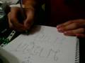 MArkus writes his name in Thai
