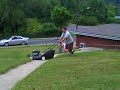 Sydney and Jackson play while Dad mows the lawn.