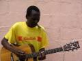 Musical refugee Daley from Zimbabwe playing his song "Harare".