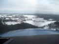 Cessna T206H G1000 VFR-approach in the winter into a Scandinavian VFR-field, landing on ice/snow covered runway, landing very short, turning off and taxiening to parking.