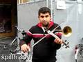 Busker with horn violin (Stroh violin) in front of Antwerp Central Station