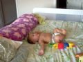 Alex plays by himself on bed