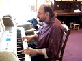 Rev. Bob Pitcher plays inimicable keyboards to the elderly of Llanidloes, Powys in Maesywennol Daycentre.