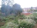 Dave & Mariluz on the train from Dharmapuri to Bangalore - countryside and city view from train