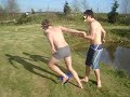 jack and john jumping into john's pond to fish out a croquet ball that john lost by hitting it into the pond trying to win the game. he is a loser.