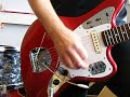 A Fender Jaguar CIJ in candy apple red w. matching head, with a Seymour Duncan Vintage bridge pick up.Strings: DÀddario Chromes 12-52. For my opinion you have to play flatwounds for this great 60`s sound. AND: Don`t use thin strings on a Jaguar! Whith thicker strings you get  more tension onto the bridge and a bit more sustain. When you use less than 11 gauge you will have the well known problems with the bridge, buzzing and so on... Thicker strings are even a bit louder!No hazzle at all, you can beat the guitar and even the tremolo without detuning.Played through a `63 Fender Showman with Fender Reverb unit.I`m from Germany. My bad english in the little movie is just joking! Don`t take it too serious... Twang!!! Brothers (and sisters?)!!!