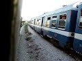 Evening rush hour at Rades, in the suburbs of Tunis. The 18:15 Tunis - Erriadh all stations train is supposed to be overtaken by the 18:20 Tunis - Borj Cedria limited-stop service before Rades, but on this occasion the two trains are side by side. MLW / Alco 040 DK 99 departs first on the 18:20, with 040 DK 98 just a coach length behind on the 18:15. Both trains accelerate, then brake for a 30 kmh speed restriction through bridge works, before 040 DK 99 accelerates away, and 040 DK 98 comes to a halt at Megrine station.