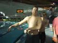 blond guy in swimming pool dancing in his blue speedo