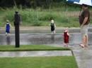 Triplets Playing in the Rain