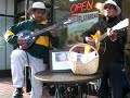 George Gange and Tomas Pan busking for Merlita's cause at the corner of Market and Embarcadero in SF
