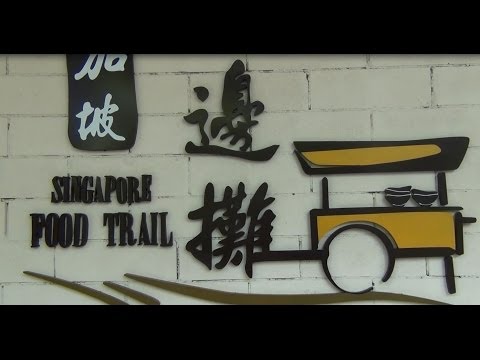 Eating street food at a Hawker Centre in Singapore Eating street food at a Hawker Centre in Singapore