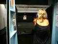 Rebecca firing a Kimber Custom II