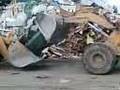 CAR CRUSHING BY TWO CAT SHOVELS.