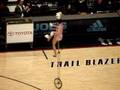 woman flips bowls on her head while riding a unicycle