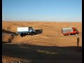 2 Unimog pulling Landrover in Sahara desert 2 Unimog pulling Landrover in Sahara desert