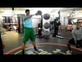 Single Arm Kettlebell Swing - Setup in a shoulder width stance, grab a kettlebell with pronated grip. Stick your hips back and sligthly swing the kettlebell between your legs. Forcefully extend your hips forward to an upright postion. As your hips move forward your arm should remain straight and swing up in the air with the kettlebell. At the top of its ascent allow the kettlebell to loose all momentum and swing back to the starting position.
