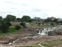 the falls park on the big sioux river in sioux falls, sd showing the old queen bee flour mill
