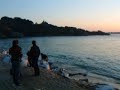 Beautiful Tregastel in Brittany, France evening with sunset and local fishing boat landing the catch of the day.