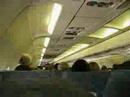Inside an airplane - guy forces tv up