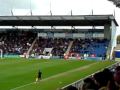 crazy Leyton Orient and Colchester United fans doing the conga during a football match