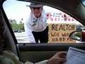 Sign of the Times: Realtor Drums up Business on the Street