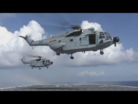 Malaysia Airlines crash: Navy ships and helicopters search for missing flight MH370