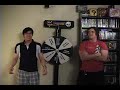 Josh and Johnny sing Today by Smashing Pumpkins in Rock Band 2 and compete for a higher score. Competition is aided by the fact that both of them will get pepper sprayed during the match. Try singing while burning in sweet sweet agony. The loser then has to spin what we call the 