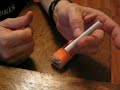 Rolling a cigarrette with a rolling machine
