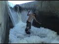 wakeskating in a waterfall