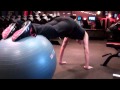 Knee Tucks on a Swiss Ball - Perform knee tucks while your feet are on a swiss ball.
