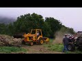 the right side of the loader was sunk into mud and grass clippings, had to pull it out uphill. then we had a tug of war.. the loader was bigger so i got a downhill handicap