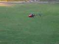 T-Rex 450 SE flying at baseball field