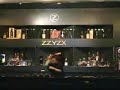 Cute Female Bartender Performing Bottle Tricks