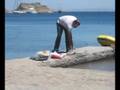 Greece, Patmos, Grikos Beach: Preparing octopus