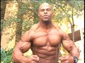 Bodybuilder Kevin LeDoux poses biceps outdoors