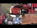 Peter Nyberg of CT Logs to Lumber, LLC brought his portable sawmill to Centerbrook Architecture recently to demonstrate how raw timber – wherever it may lie, bark and all – can be turned into boards and beams for buildings. He set up his mobile mill in 20 minutes, and in less than two hours he reduced two sizable red oak trunks (courtesy of local arborist Town Burns) into roughly 500 board feet of useable lumber – plus “waste” slabs for my wood stove.