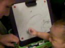 Baby Natalie draws with markers and dirty finger