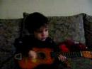 Aidan playing guitar at 2 and a 1/2