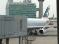 Cathay Pacific flight manouvering to dock with terminal at Hong Kong airport