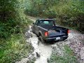 Desperately thrashing back and forth trying get out mud pit