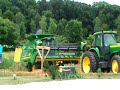 John Deere combine stuck in the muck being pulled out by a tractor and another combine. It took both to successfully pull it out. The combine had bottomed out and was buried pretty deep.